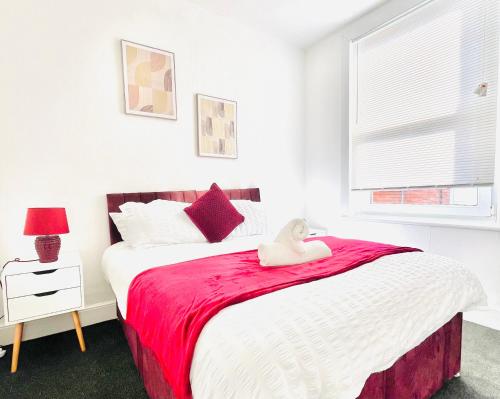 a bedroom with a large bed with a red blanket at Francis Avenue in Portsmouth