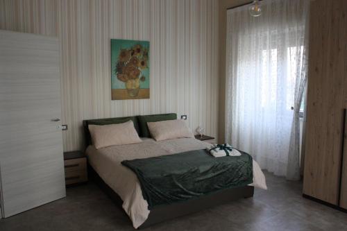 a bedroom with a bed and a painting on the wall at Casa Fabbricatore in Sant'Egidio del Monte Albino