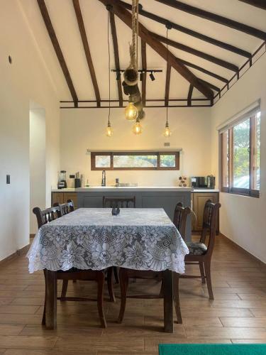 a kitchen with a table and chairs in a room at Hotel Sol de la Montaña Villa de leyva in Villa de Leyva