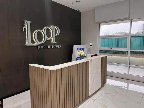a lobby with a top north tower sign on a wall at Aesthetic 2 Bedroom The Loop Tower Condo Unit in Cagayan de Oro