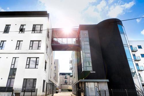 a tall building with the sun shining behind it at Steelworks at Copley Court in Cork