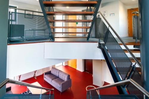a staircase in a building with a chair and a couch at Steelworks at Copley Court in Cork