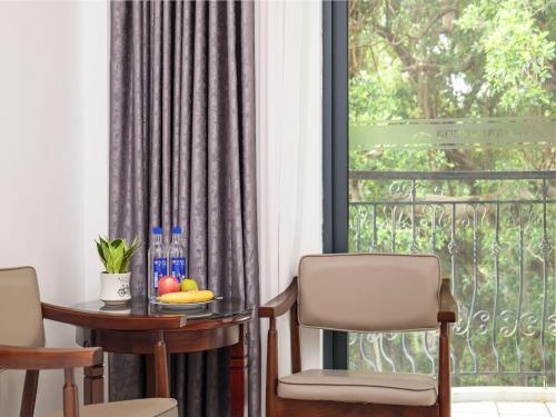 a room with a table and chairs and a window at Xiamen Kulangsu Resort Hotel in Xiamen