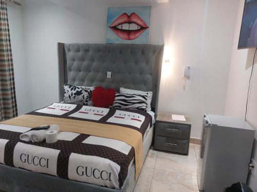 a bedroom with a bed with a lips picture on the wall at Gold Crown International Hotel With Complementary Breakfast and WiFi in Johannesburg