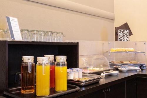 a group of bottles of drinks on a counter at Al Centro in Verbania