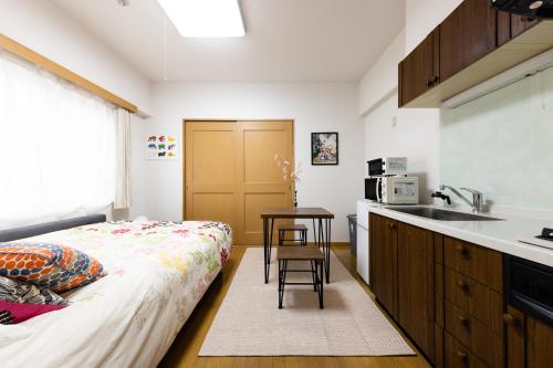 a kitchen with a bed and a sink in a room at SHIBUYA Bright Modern 40sqm Apartment FAMILY FRIENDLY!! in Tokyo