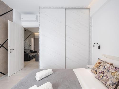 a bedroom with a large sliding glass door at Elio Apartment 1 in Chania Town