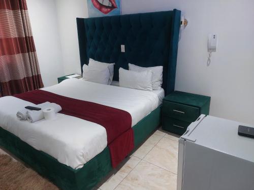 a hotel room with a bed with two towels at Gold Crown International Hotel With Complementary Breakfast and WiFi in Johannesburg