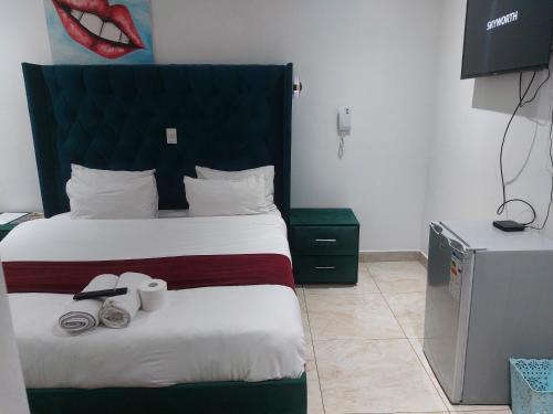 a hotel room with a bed with a large headboard at Gold Crown International Hotel With Complementary Breakfast and WiFi in Johannesburg