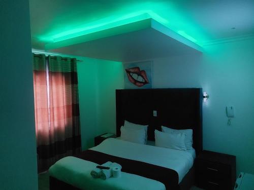 a room with a bed with a green light at Gold Crown International Hotel With Complementary Breakfast and WiFi in Johannesburg