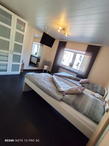 a bedroom with a large bed in a room at Ferienwohnung Landblick - Keine Monteure - in Pirmasens
