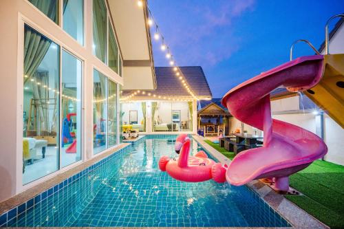 a swimming pool with a slide in a house at M4 Billion Pool Villa Cha-am in Cha Am