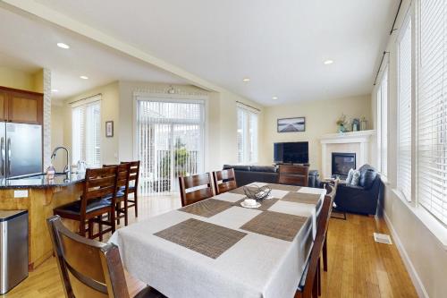 a kitchen and dining room with a table and chairs at Fairway and Far Away in Seaside