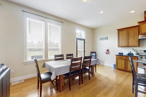 a kitchen and dining room with a table and chairs at Fairway and Far Away in Seaside