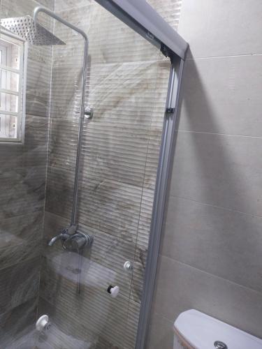 a shower with a glass door in a bathroom at Gold Crown International Hotel With Complementary Breakfast and WiFi in Johannesburg
