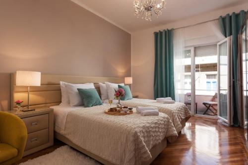 a bedroom with a large bed with green curtains at Apolon - Apartman in the center of old town in Split