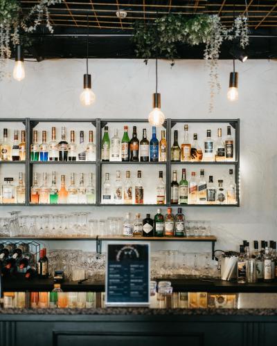 a bar with bottles of alcohol on the wall at Hotel Waltikka in Valkeakoski