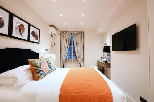 a bedroom with a large bed and a window at Twenty Nevern Square Hotel in London
