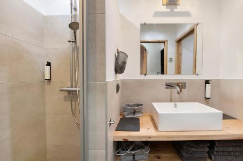 a bathroom with a sink and a shower at Appartamenti I Portici in Santa Caterina Valfurva