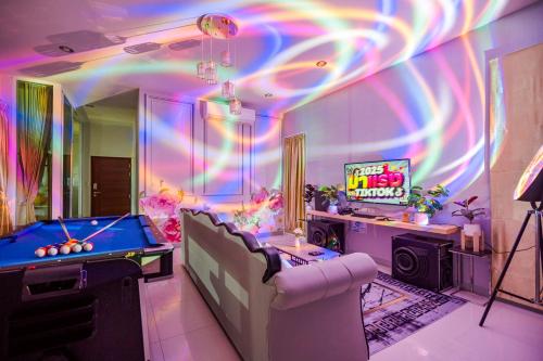 a room with a pool table and a tv at M4 Billion Pool Villa Cha-am in Cha Am