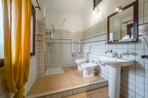 a bathroom with a toilet and a sink at Agrolea in Terme Vigliatore