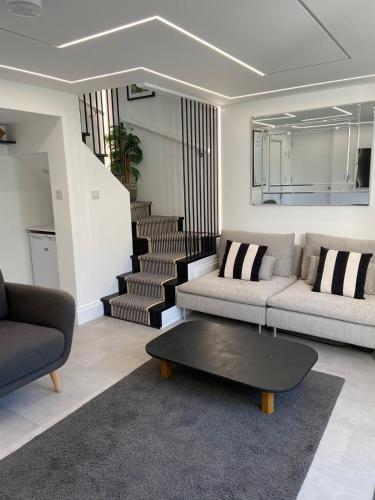 a living room with a couch and a coffee table at The Motor House in Worthing