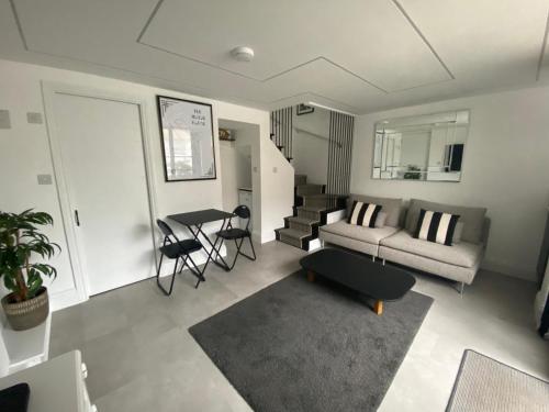 a living room with a couch and a table at The Motor House in Worthing