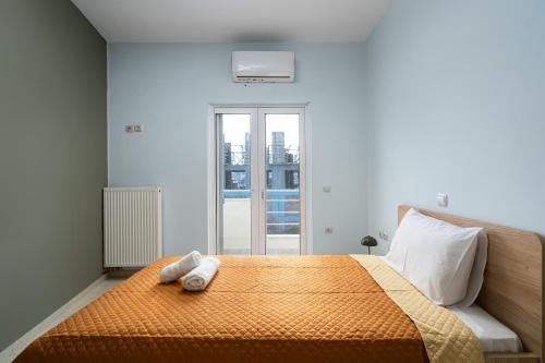 a bedroom with a bed with two towels on it at Sitia Oasis Residence in Sitia