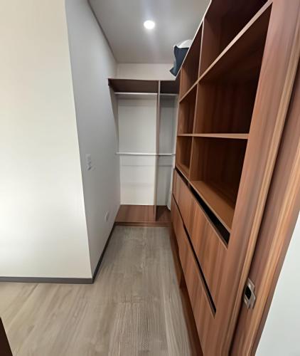 a walk in closet with a wooden door at Edificio Urban in Cajicá