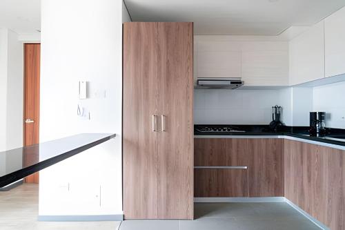 a kitchen with wooden cabinets and a counter top at Edificio Urban in Cajicá