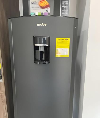 a refrigerator with a coffee maker on top of it at Edificio Urban in Cajicá