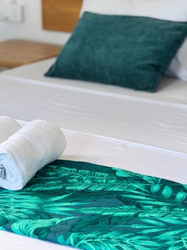 a roll of toilet paper sitting on a bed at Villa Océan Gravier Rodrigues in Mt Bois Noir