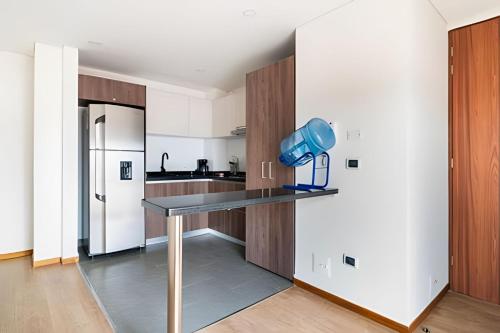 a kitchen with a table with a blue blender on it at Edificio Urban in Cajicá