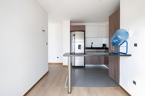 a kitchen with a table with a blue object on it at Edificio Urban in Cajicá