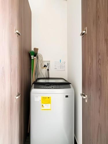a small refrigerator in a room next to a door at Edificio Urban in Cajicá