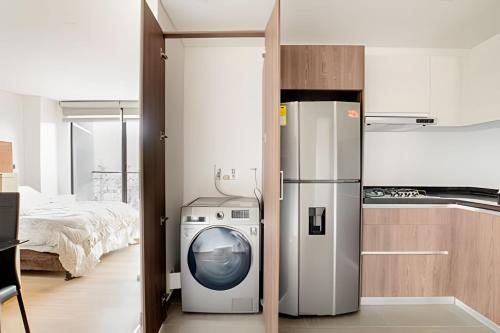 a kitchen with a refrigerator and a washing machine at Edificio Urban in Cajicá