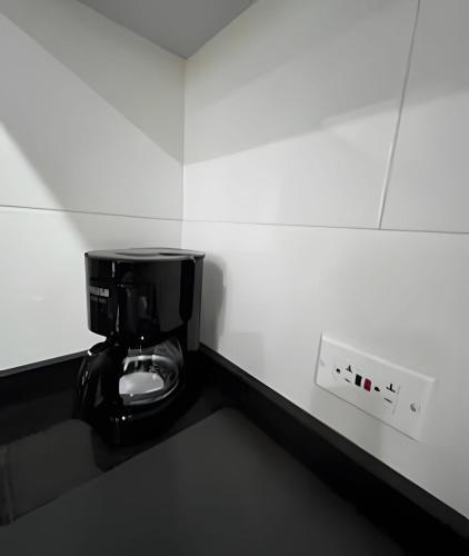 a bathroom with a toilet in a white wall at Edificio Urban in Cajicá