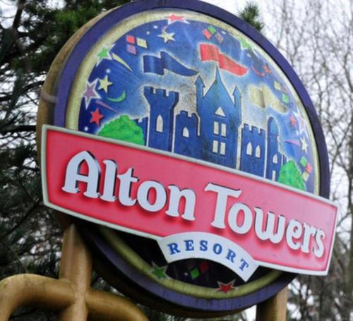 a sign for an alton towers resort at orchard meadow shepherd huts leek-buxton-ashbourne in Upper Elkstone
