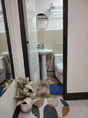 a bathroom with a tub and a toilet and a sink at Cozy Bella in Jalajala