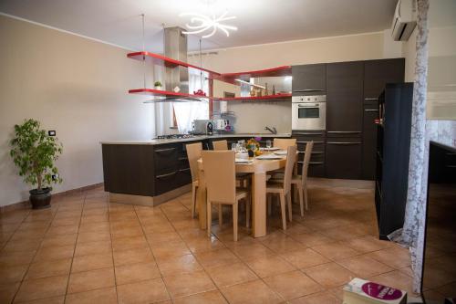 a kitchen with a table and chairs in it at Villa Anna in Genzano di Roma