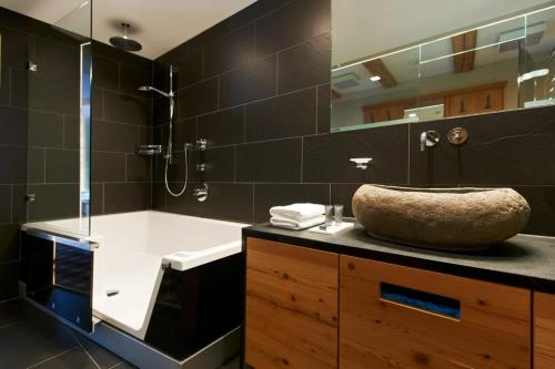 a bathroom with a sink and a shower at Sport- und Genusshotel Silvretta in Ischgl