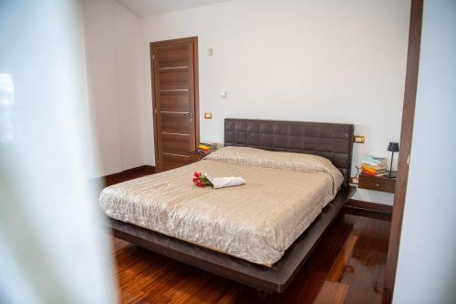 a bedroom with a bed with flowers on it at Villa Anna in Genzano di Roma