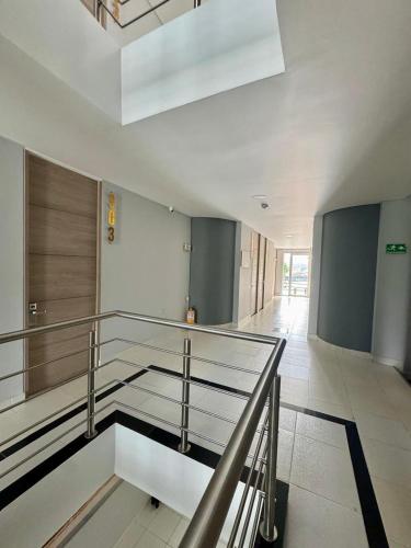 a lobby with a staircase in a building at HOTEL G22 COLECTION in Florencia