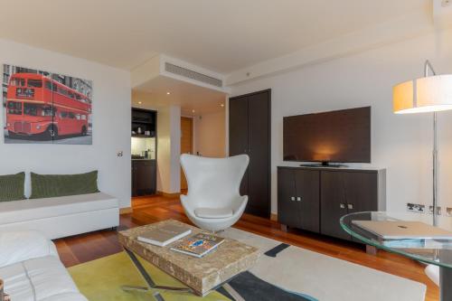 a living room with a red double decker bus on the wall at Pestana Chelsea Bridge Hotel & SPA in London