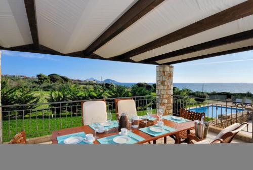 a patio with a table and chairs and a pool at Yialenia Estate in Rikia