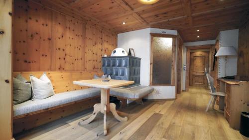 a wooden room with a bench and a table at Sport- und Genusshotel Silvretta in Ischgl