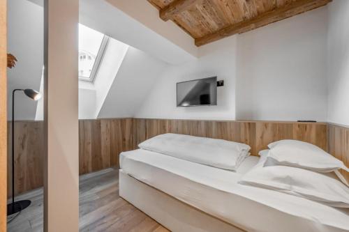 a bedroom with a bed and a tv on a wall at Sport- und Genusshotel Silvretta in Ischgl