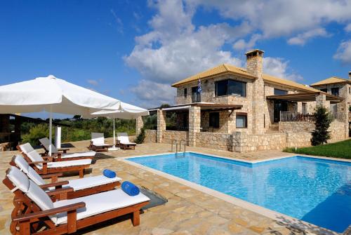 a villa with a swimming pool and a house at Yialenia Estate in Rikia