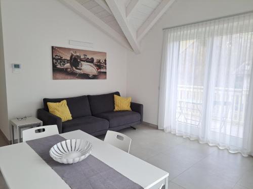a living room with a couch and a table at La mansarda di Rossella in Pieve Di Ledro