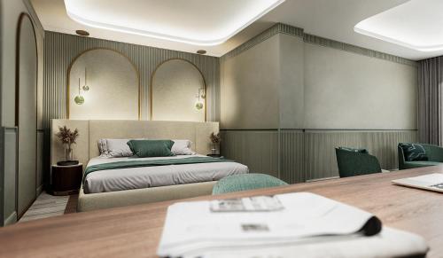 a bedroom with a bed and a table and chairs at Grand Hotel Bristol in Stresa